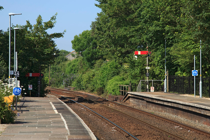 St 
 The western end of St. Erth station with its down starter semaphores controlled by the signal box at the eastern end. The station retains much of it character and is well maintained. It is served by mainline trains to and from Penzance and also local services to and from St. Ives that either terminate on one of the two remaining bay platforms or work forward to Penzance. Since the creamery closed, that was located very close to the front of the station, in 1980, freight is pretty rare now. 
 Keywords: St.Erth up starter signals