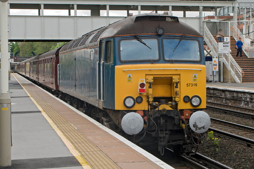 57316, outward leg The Channel Coast Express, 06.53 Doncaster-Brighton (1Z64, 9L), Kensington Olympia station 
 Snaking its way through Central London at Kensington Olympia station 57316 (Formally named 'Fab 1') is pictured at the rear of the 1Z64 Channel Coast Express charter. Passengers left Doncaster at just before 07.00 with the destination of Brighton reached just before noon (or just after it as the train was delayed by some thirteen minutes). There were a number of 'normals' on Olympia station but none took any notice as the charter passed more engrossed on the 'phones such is the world we live in today! 
 Keywords: 57316 The Channel Coast Express, 06.53 Doncaster-Brighton 1Z64 Kensington Olympia station Virgin Thunderbird