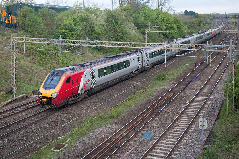 221143 & 221109, VT 05.38 Lancaster-London Euston (1A04, 1L), Victoria Bridge 
 221143 'Auguste Picard' and 221109 'Marco Polo' head past Victoria Bridge just south of Roade on the WCML working the 05.38 Lancaster to London Euston. An eight coach Voyager seems a lot for a service that runs very early in the morning, but I suspect that this is more of a move to get a set to London to work a service north again. 
 Keywords: 221143 221109 1A04 Victoria Bridge