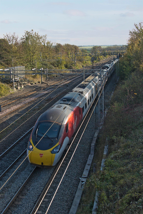 390040, VT 12.40 London Euston-Manchester-Piccadilly (1H67, 3L), Victoria Bridge 
 390040 passes Victoria Bridge forming the 12.40 1H67 Euston to Manchester Piccadilly. Yes, I know that this subject is in the shade but I like the dappling on the side of the train and the lovely warm light in the background so s*d the rules! 
 Keywords: 390040 12.40 London Euston-Manchester-Piccadilly 1H67 Victoria Bridge