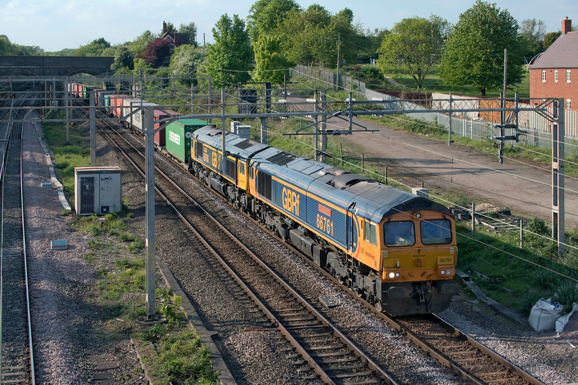 66761 & 66706, 14.18 Trafford Park-Felixstowe North (4L18, 2L), site of Roade station 
 On the way back from buying some provisions I thought I would wait ten minutes for the 4L18 14.18 Trafford Park to Felixstowe Freightliner service. I am glad I did as it was double-headed by two matching and named GBRf Class 66s that look grand in the afternoon sunshine. 66761 'Wensleydale Railway Association 25 Years 1990-2015' and 66706 'Nene Valley' lead the train past the site of Roade station. I wondered if the second Class 66 had failed but both were firmly under power as they headed south. 
 Keywords: 66761 66706 14.18 Trafford Park-Felixstowe North 4L18 site of Roade station Wensleydale Railway Association 25 Years 1990-2015 Nene Valley GBRf