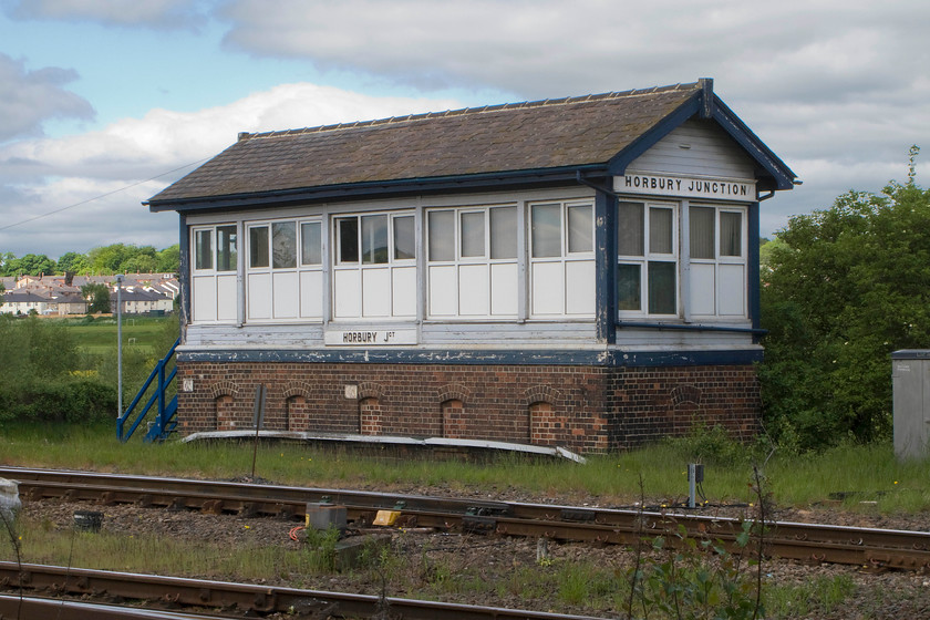 Horbury Junction signal box (LNWR, 1927) 
 Despite the ghastly upvc treatment afforded to Horbury Junction signal box its LNWR lineage cannot be disguised even if the finials having been crudely cut from the gable ends! The box was built in 1927 to their 5+ design and contained a sixty five-lever frame, but with no semaphores now in use, most of the levers will be painted white and oou. Despite its relatively isolated and pleasant looking location, this image is deceiving, it is right next to the very busy M1 motorway located below a bridge between junctions thirty-nine and forty. 
 Keywords: Horbury Junction signal box LNWR 1927