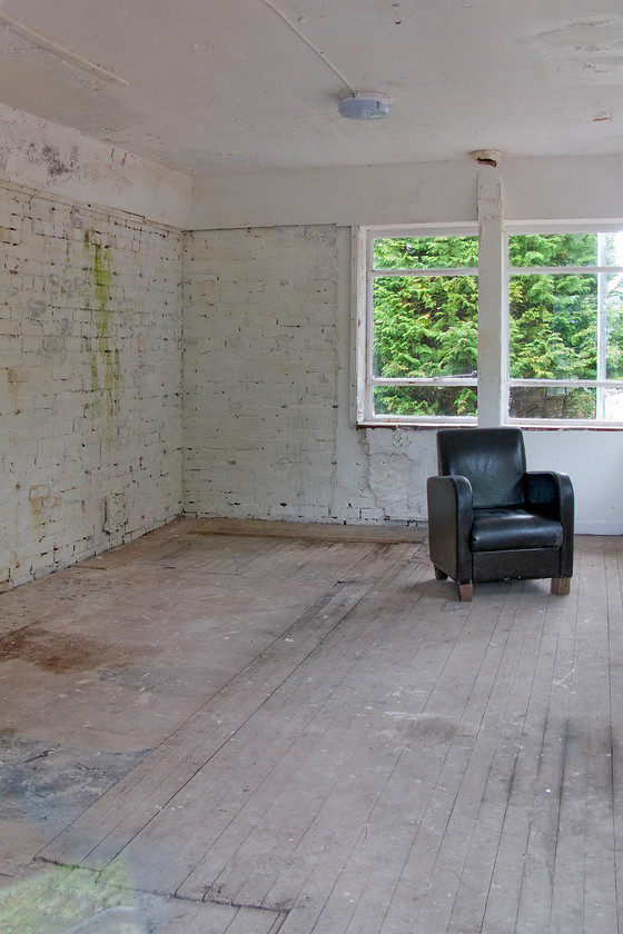 Interior, Spean Bridge signal box (Closed) (LNER, 1949) 
 Looking more like an arthouse scene than the interior of a former signal box. Spean Bridge signal box was closed in 1988 and has been in use as a greenhouse but now appears to be more of a minimal form of a living room! Notice the flat boarding on the floor to the left that marks where the levers emerged from the frame room below. Also, notice the hole in the ceiling where the chimney from the fire exited the box. 
 Keywords: Spean Bridge signal box LNER 1949