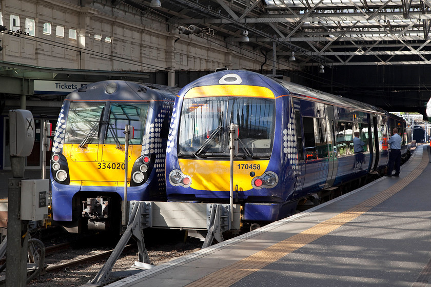 334020, SR 10.37 Edinburgh Waverley-Milngavie (2M37) & 170458, SR 10.33 Edinburgh Waverley-Dunblane (2P59), Edinburgh Waverley station 
 Whilst waiting for my wife and son to meet me on the concourse at Waverley, I took the opportunity to take a final few images. As the morning sunshine comes through the recently restored glass roof, 334020 waits to leave with the 10.37 to Milngavie with 170458 next to it that will form the 10.33 to Dunblane. 
 Keywords: 334020 10.37 Edinburgh Waverley-Milngavie 2M37 170458 10.33 Edinburgh Waverley-Dunblane 2P59 Edinburgh Waverley station