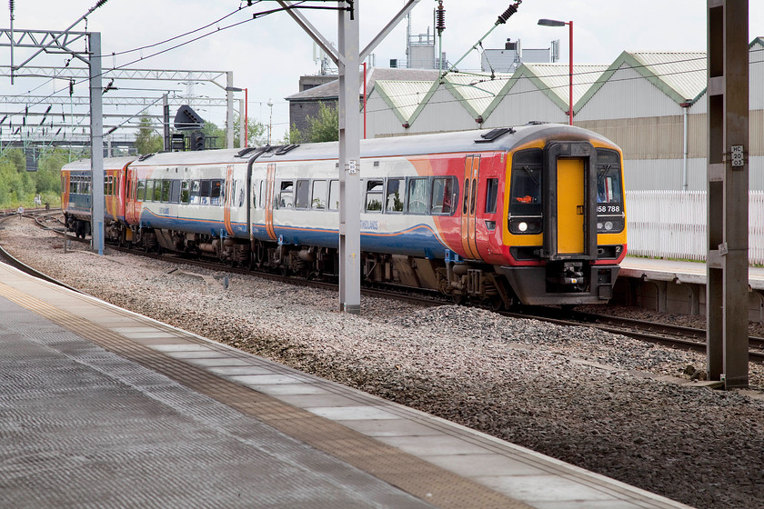 158788 &153384, EM 14.42 Derby-Crewe (1K17), Stoke-on-Trent station 
 An East Midlands combo arrives at Stoke-on-Trent station. The first two carriages are unit 158788 with a single car 153384 bringing up the rear. Notice the contrasting liveries of the two units. They are woking the 14.42 1K17 Derby to Crewe. 
 Keywords: 158788 153384 14.42 Derby-Crewe 1K17 Stoke-on-Trent station