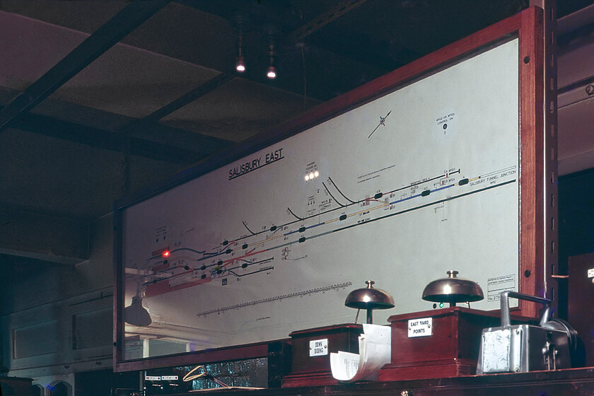 Track diagram, Salisbury East signal box 
 The track layout diagram inside Salisbury East signal box is seen above the instrument machine. Notice the Bradic lamp sitting on the shelf next to the East Yard Points bell box. Also, notice the track circuit indicating a train passing the station indicating the presence of the Tiverton Junction to Fawley empty oil tanker train led by 33029. Unfortunately, due to it being dark, I was not able to capture this train on film or any other of the evening workings for that matter. 
 Keywords: Track diagram Salisbury East signal box