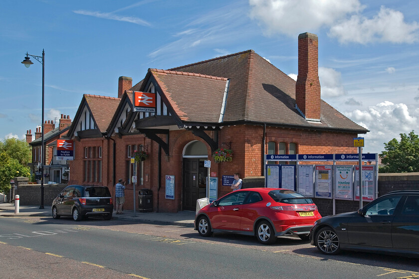 Frontage, Poulton-le-Fylde station 
 The frontage of Poulton-le-Fylde station is seen with Andy studying something interesting! The delightful station is at street level with the lines passing underneath and was opened in 1896 replacing an earlier station on a different alignment a short distance away. 
 Keywords: Frontage Poulton-le-Fylde station