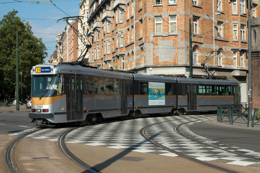 7960, service 51 Stade-Van Haelen, junction of Rue-de-la Fortd Houthuist & Negende Linielaan, Brussels 
 The tram network, as in many European cities, is comprehensive and well patronised. Here, tram 7960 works service 51 from Stade to Van Haelen rounds a sharp curve to make its way along the side of the Brussels Canal close to the city centre.