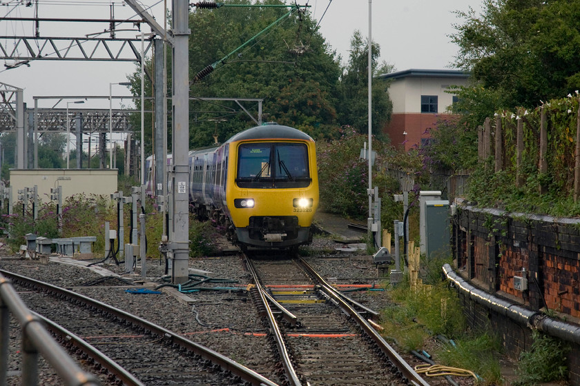 323228, stabled for 20.53 Crewe-Manchester Piccadilly (2H27), Crewe station 
 Held just north of Crewe station by the ground signal to the right-hand side 323228 awaits its turn to enter the station in the quarter of an hour or so. Once at the platform, it will then work the 2H27 20.53 to Manchester Piccadilly that will travel via Alderley Edge but from Wilmslow, I am not sure if it would take the Gatley or the Stockport route, advice anybody? 
 Keywords: 323228 20.53 Crewe-Manchester Piccadilly 2H27 Crewe station Northern Trains