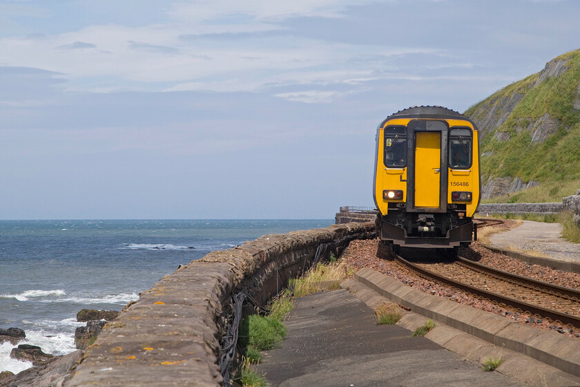 156486, NT 12.10 Carlisle-Barrow-in-Furness (2C52, 10E), Lowcra Point NY978215 
 A photograph that did not go quite to plan! I was hoping for a bit more of a curve so the length of the train could be seen rather than this head-on view. Nonetheless, the combination of sun, blue sky, sea and a train makes it acceptable! 156486 trundles along the sea wall at Lowcra Point working the 12.10 Carlisle to Barrow-in-Furness service. Andy was located several hundred yards behind me and I suspect that his image was better than mine. 
 Keywords: 156486 12.10 Carlisle-Barrow-in-Furness 2C52 Lowcra Point NY978215 Northern