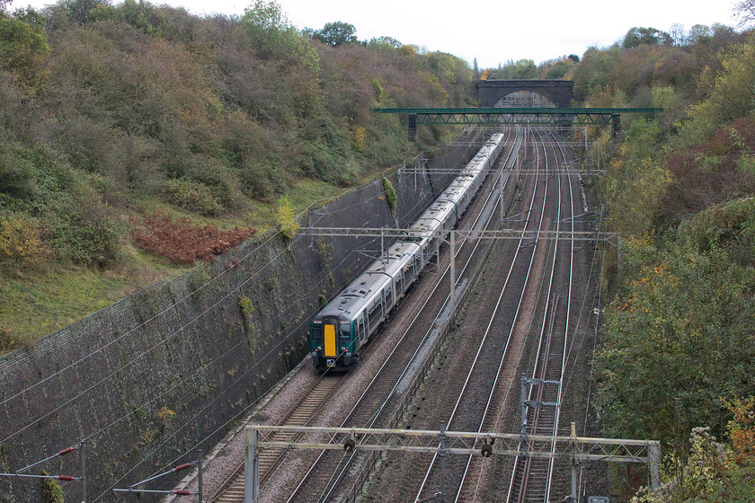 350240 & 350377, LN 13.25 Northampton-London Euston (2Z36, 6E), Roade cutting 
 350240 and 350377 heads south through Roade cutting forming the 13.25 Northampton to London Euston service. This was a service that was running as 2Z36, as part of London Northwestern's emergency timetable to cope with acute staff shortages. It was interesting to note that virtually all of the services arrived a little early, in the case of this one, six minutes up. Was this a cynical ploy by the company, after a disastrous week, to re-time their services with generous recovery and slack times in order to avoid further complaints and delay repay claims; I'll let you decide? 
 Keywords: 350240 350377 13.25 Northampton-London Euston 2Z36 Roade cutting