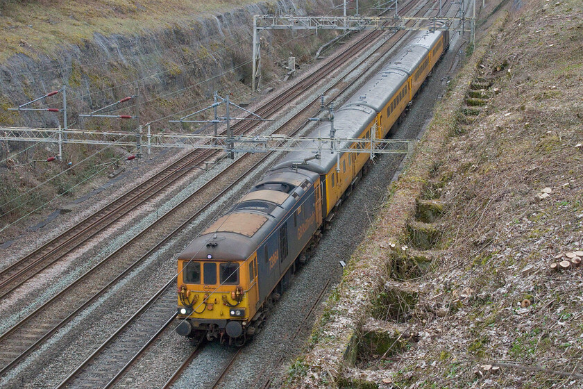 73964 & 73963, 10.55 Hither Green-Derby RTC (1Z10, 55E), Roade cutting 
 The third train of the three that I went out to see on this rather cold and dull spring Sunday afternoon passes through Roade cutting. The Network Rail test train had been undertaking survey work on Southern metals with several postings revealing where it had been over the last few days. I suspect that the 10.55 Hither Green to Derby RTC run operated by 73964 Jeanette (front) and 73963 Janice (rear) was simply returning to its base rather than undertaking survey work as this is usually a weekly run operated by one of NRs HSTs on a Tuesday. In addition to this, the train gradually gained time throughout its run arriving nearly an hour early at Derby. 
 Keywords: 73964 73963, 10.55 Hither Green-Derby RTC 1Z10 Roade cutting ED Network Rail Jeanette Janice