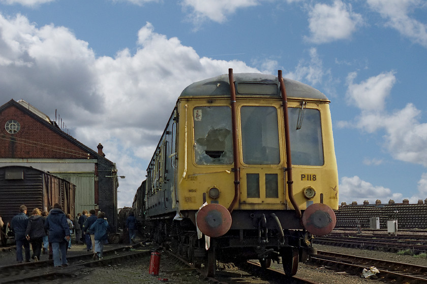 W55018 (P118), awaiting scrapping, Swindon Works 
 Withdrawn at Laira Depot sometime in early 1976, this class 121 'Bubble Car' DMU awaits its fate at Swindon Works. P118 was a 1958 unit fitted with 2 AEC engines producing a megre 150bhp between them. W55018 spent its later life on the Devon and Cornwall branch lines. Before that it was a Midland machine used in and around the Birmingham area. To the left, notice the old weighbridge. Now this has reincarnated into The Weighbridge Brewhouse located on the newly built Penzance Drive.