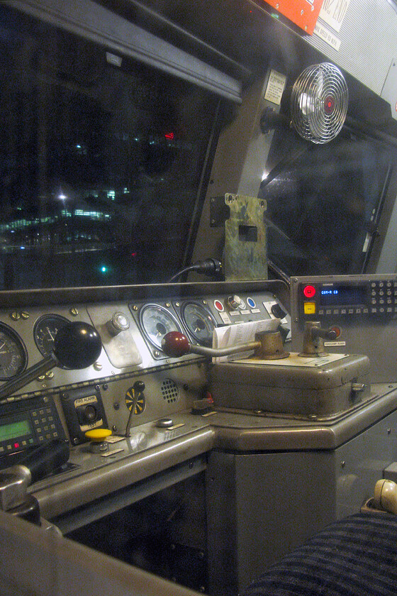 Cab, 57313, 22.18 London King's Cross-Southall WCR ECS (5Z48), London King's Cross station 
 The interior of 57313 is seen through the side window as it stands at Kings's Cross. Soon, the driver will enter the cab and take the empty coaching stock from The Lindum Fayere charter the short distance to Ferme Park. Here, the Class 57 would run round and then take the train back to WCR's Southall base adjacent to the GWML. 
 Keywords: Cab 57313 22.18 London King's Cross-Southall WCR ECS 5Z48 London King's Cross station WCR West Coast Railways