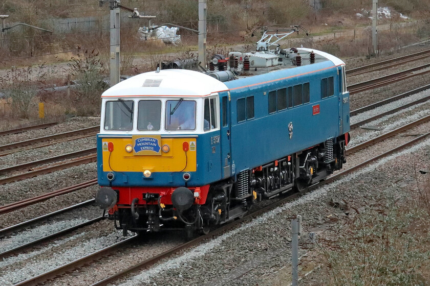 86259, 13.15 Acton Lane Reception Sidings-Rugby CS (0Z86, 25E), site of Roade station 
 Having been involved in railtour duties the previous day, 66259 'Peter Pan/Les Ross' returns light engine to its stabling point in Rugby carriage sidings. Due to the closure of the Northampton loop due to weekend engineering works, the 0Z56 13.15 ex Acton Lane Reception Sidings is travelling on the down fast line. It is seen passing Roade at the site of the former station. 
 Keywords: 86259 13.15 Acton Lane Reception Sidings-Rugby CS 0Z86 site of Roade station Les Ross Peter Pan