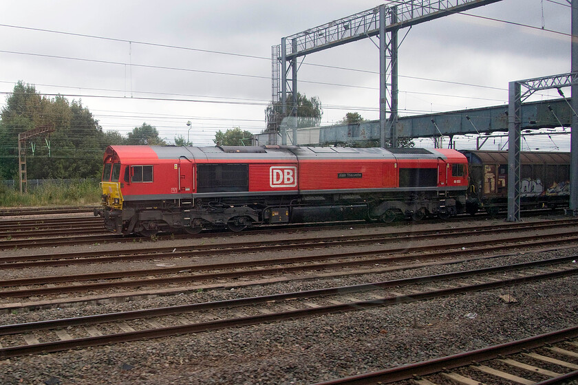 66055, 06.53 Dollands Moor-DIRFT (6M45, RT), Wembley Yard 
 66055 'Alain Thauvette' stands in Wembley Yard at the head of the daily 6M45 Dollands Moor to Daventry bottled water train. It has a lengthy layover in the yard of anything up to four hours before heading north down the WCML the relatively short distance to DIRFT compared to where it originated in Europe. 
 Keywords: 66055 06.53 Dollands Moor-DIRFT 6M45 Wembley Yard Alain Thauvette