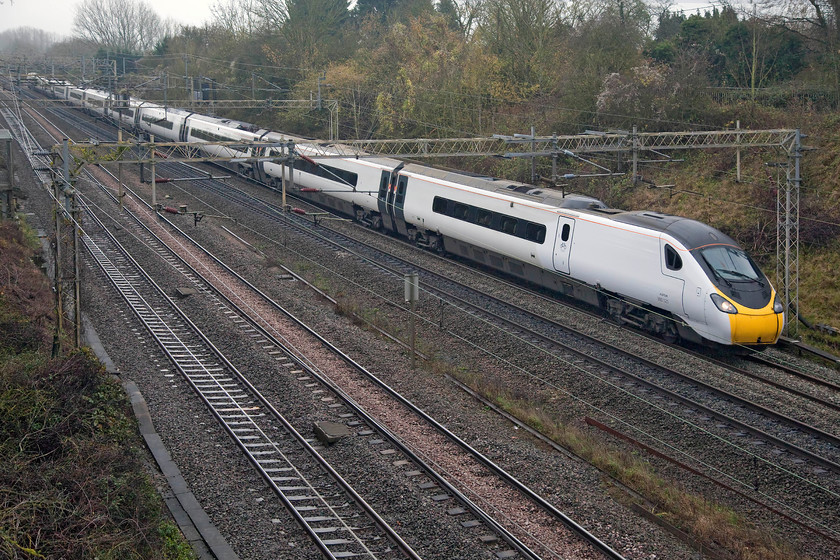 390121, VT 10.43 London Euston-Edinburgh Waverley (9S60, 7L), Victoria bridge 
 Looking nude, 390121 heads north past Victoria bridge in south Northamptonshire with the 10.43 London Euston to Edinburgh Waverley. The plain liveried and un-branded Pendolino ready for the new operator to make its mark on it next month certainly brightens up an incredibly drab November day! 
 Keywords: 390121 10.43 London Euston-Edinburgh Waverley 9S60 Victoria bridge Virgin Trains Pendolino