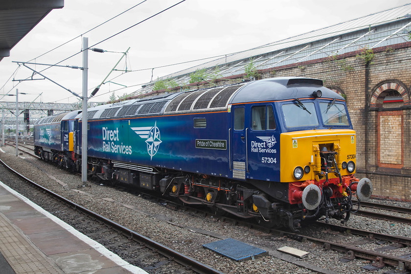 57304 & 57309, stabled Thunderbirds, Crewe station 
 57304 'Pride of Cheshire' and 57309 'Pride of Crewe' stand in the middle road at Crewe station. These two class 57s were not on-dispaly at the nearby DRS Open Day as they had to perform their Thunderbird duties as contracted by Virgin West Coast. These, as do other class 57s, sit at strategic locations the length of the WCML in case of Pendolino or Voyager failure. They then rush to the aid of the stricken train and clear it from the mainline as quickly as possible. 
 Keywords: 57304 57309 Thunderbirds Crewe station