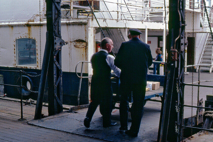 Loading ramp, MV Farringford, New Holland Pier 
 A number of small four-wheeled trolleys were used to carry small items on and off the MV Faringford as part of its operations between Hull Corporation Pier and New Holland Pier. One of these trolleys is seen in use as staff load the vessel for the 13.15 sailing to Hull. Approaching the end of its use on the route, with just a week to go before the opening of the Humber bridge the condition of MV Farringford leaves a little to be desired given the gouge and the rust stains evident in this photograph. 
 Keywords: Loading ramp MV Farringford New Holland Pier Sealink