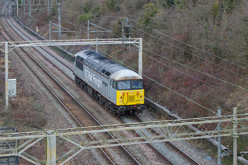 56091, 10.57 Leicester LIP-Willesden DC Rail Sidings (0Z56, 14E), A508 bridge 
 56091 'Driver Wayne Gaskell' seems to be spending a lot of its time running light engine up and down the WCML. I saw it earlier in the week heading north past Milton Keynes in the company of 60046 'William Wilberforce' heading north, see... https://www.ontheupfast.com/p/21936chg/30049736338/x60046-56091-11-30-willesden-dc-rail and here it is on its own this time heading south as the 0Z56 10.57 Leicester LIP to Willesden DC Rail Sidings. I am not a fan if light engine photographs and do not go out of my way to digitally capture them however, when it's a Grid I will normally make an exception! 
 Keywords: 56091 10.57 Leicester LIP-Willesden DC Rail Sidings 0Z56 A508 bridge DCR Grid Driver Wayne Gaskell