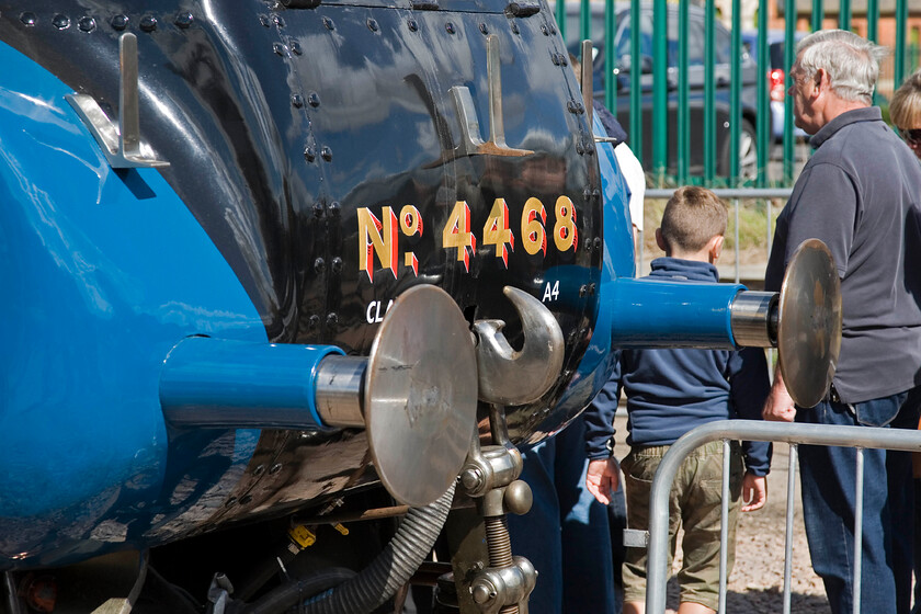 4468, on display, Mallard 75 celebrations, Grantham Yard 
 A close-up photograph of the highly polished front end of 4468 'Mallard' as it stands on display in a specially prepared yard adjacent to Grantham station as part of its seventy-five years celebrations. The young lad and the grey-haired chap were part of a lengthy queue of punters patiently waiting to enter the cab of the record-breaking locomotive 
 Keywords: 4468 Mallard 75 celebrations Grantham Yard Mallard