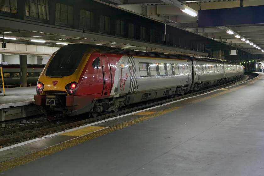 221142, VT 17.40 London Euston-Glasgow Central (9S97, 1L), London Euston station 
 This is definitely NOT how I would like to travel to Glasgow from London late on a winter Sunday evening! I'm sure that train controllers have their reasons for running a thirsty DMU 400 miles under fully energised 25kv overhead wires but I could do with explaining to me; what a waste! 221142 'Bombardier Voyager' waits to leave the capital with the 9S97 to Glasgow Central. 
 Keywords: 221142 17.40 London Euston-Glasgow Central 9S97 London Euston station