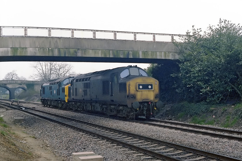 37299 & 37270, up LEs, Bathampton Junction 
 37299 and 37270 run light engine past Bathampton Junction on the GWML just east of Bath. I don't have it recorded, but it is more than likely that they were going to diverge from the mainline just behind me and then head along the Avon Valley to Westbury. 37299 looks somewhat work-stained leading the well presented 37270. 37299 survived until being cut-up at Booth's scrapyard in Rotherham at the beginning of 2013. However, 37270 is still with us as 37409 as a DRS locomotive. Indeed, at the time of writing, I observed it at Norwich station just three weeks previous to writing this text in the autumn of 2018. 
 Keywords: 37299 & 37270, up LEs, Bathampton Junction