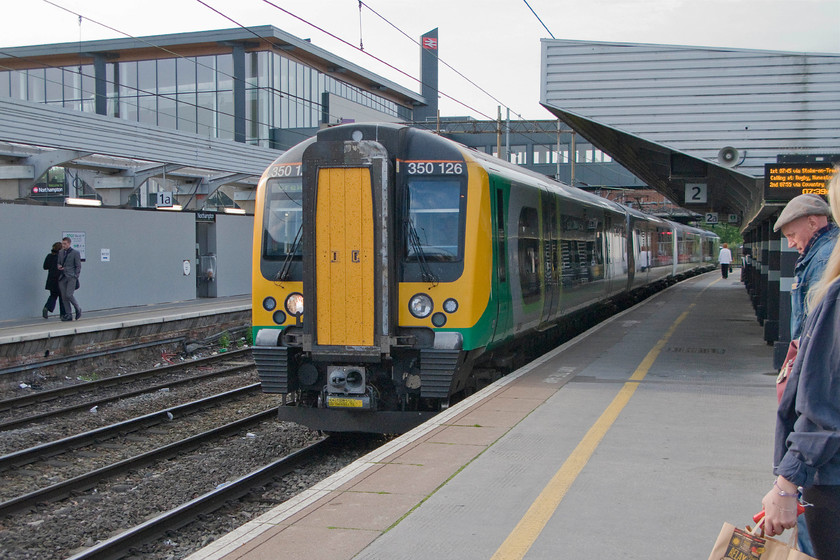 350126, LM 06.24 London Euston-Crewe (2U23), Northampton station 
 Our journey north to Knutsford involved us travelling on three trains. This first leg was the 06.24 Euston to Crewe from Northampton where 350126 is seen arriving. Notice the boarding on platform one covering up the work still taking place re-building the station. 
 Keywords: 350126 06.24 London Euston-Crewe 2U23 Northampton station London Midland Desiro