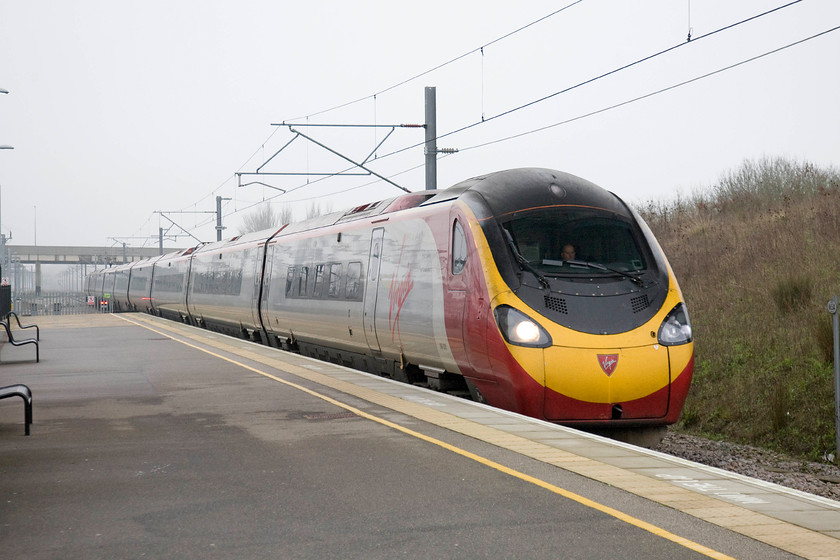 390020, VT 10.20 London Euston-Manchester Piccadilly (1H18), Milton Keynes Central station 
 For the second leg of my journey to Bolton, I took the 10.20 Euston to Manchester Piccadilly from Milton Keynes. 390020 arrives into the station ready to whisk me northwards. Despite their weaknesses, not least are their stinking toilets, something that still has still not been sorted out some sixteen years after their introduction, they do a fairly efficient job of getting passengers about. 
 Keywords: 390020 10.20 London Euston-Manchester Piccadilly 1H18 Milton Keynes Central station