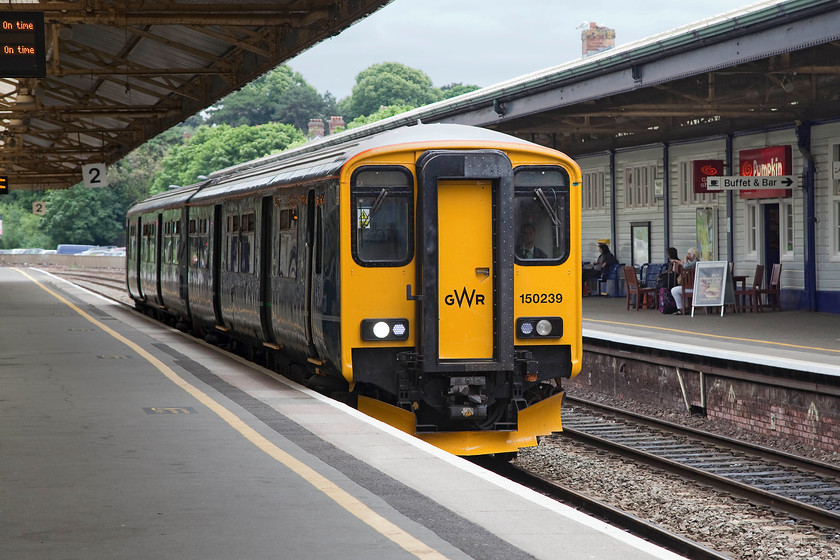 150239, GW 13.43 Plymouth-Newton Abbot (2A63, RT), Newton Abbot station 
 About to complete its journey, the 13.43 Plymouth all-station service arrives into Newton Abbot formed of 150239. Whilst Newton Abbot station retains a lot of its GW character, it is a shadow of its former self with only three platforms now in use and a very basic track configuration since it was extensively remodelled in 1987 at the same time the mechanical signalling was swept away. 
 Keywords: 150239 2A63 Newton Abbot station