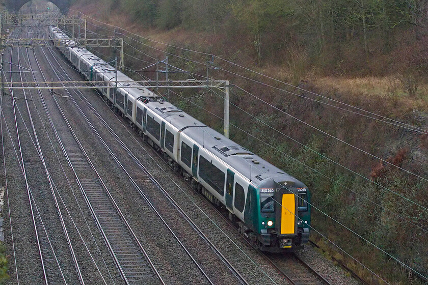 350240, 350253 & 350251, 11.09 Northampton EMD-Wembley Yard (5A11, 36E), Hyde Road bridge 
 What appears to be a perfectly normal Class 350 working passes through Roade on a foggy and cold Saturday morning between Christmas and New Year; however, everything is not as it seems. Composed entirely of Class 350/2 units the 11.09 Northampton to Wembley Yard running as 5A11 is formed by 350240, 350253 and 350251. The units have had all of their vinyl branding removed suggesting that this tranche is heading off lease for storage awaiting further developments with Northern possibly interested in them. 
 Keywords: 350240 350253 350251 11.09 Northampton EMD-Wembley Yard 5A11 Hyde Road bridge London Northwestern Desiro