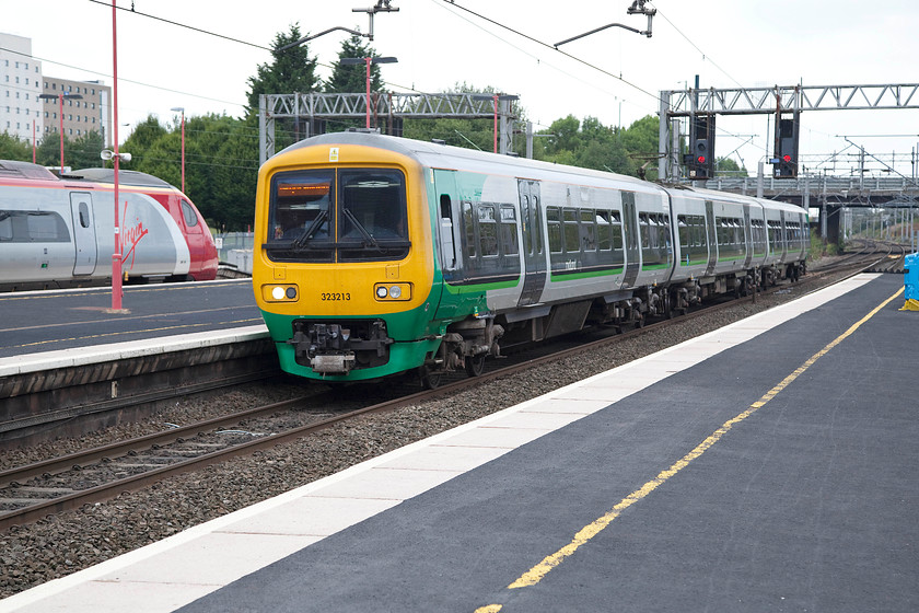 323213, LM 15.39 Birmingham New Street-Birmingham International (2I19) & 390134, VT 14.43 London Euston-Edinburgh Waverley (9S80), Birmingham International station 
 Whilst 390134 'City of Carlisle' waits at Birmingham International working the 14.43 Euston to Edinburgh, 323213 arrives with the terminating 15.39 from New Street. International station is a busy station that will no prizes for its attractive design. However, as a functional structure, it does what its supposed to do be it getting visitors to and from the NEC or on their holidays from Birmingham International airport. 
 Keywords: 323213 15.39 Birmingham New Street-Birmingham International 2I19 390134 14.43 London Euston-Edinburgh Waverley 9S80 Birmingham International station