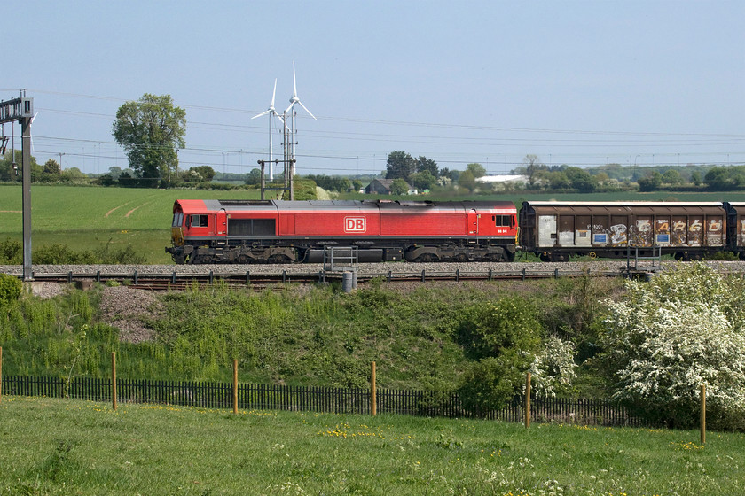 66041, 07.05 Dollands Moor-DIRFT (6M45, 8L), Roade Hill 
 With the blackthorn (prunus spinosa) in full flower, the red of the DB Class 66 and the lush greenery makes for a feast of colour all set against a brilliant blue sky! 66041 leads the daily 07.05 Dollands Moor to Daventry (DIRFT) bottled water train past Roade Hill in south Northamptonshire. I really like this location for an afternoon spot but the owner of the field that is the home to a number of alpacas has just installed the large wooden posts across the foreground and has planted a line of trees in front of the palisade fence so it will not remain like this forever! 
 Keywords: 66041 07.05 Dollands Moor-DIRFT 6M45 Roade Hill DB