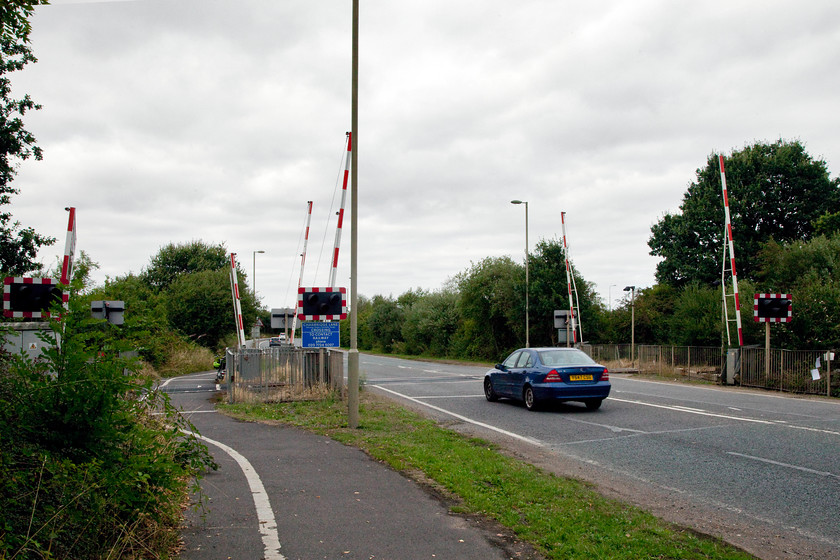 East-West line looking NE, Bicester Eastern Perimeter Road crossing 
 When (if?) the east-west rail link is developed I suspect that this level crossing over the Bicester Eastern Perimeter road will disappear and a huge bridge constructed. Network Rail's obsession with the elimination of level crossings accross the network will mean a huge number of bridges will be needed over this line in the eighteen miles or so between Bicester and Bletchley. 
 Keywords: East-West Bicester Eastern Perimeter Road crossing