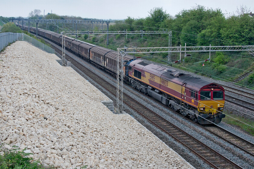 66133, 06.37 Dollands Moor-DIRFT (6M45, RT), Ashton Road bridge 
 Now completed nearly two years ago the bank stabilisation work at Ashton Road bridge near Roade is just beginning to weather a little. 66133 leads the daily 6M45 Dollands Moor to DIRFT bottled water train past the spot that is once again up to its normal length after some months of it being considerably shorter than normal with the train not even running on some days! 
 Keywords: 66133 06.37 Dollands Moor-DIRFT 6M45 Ashton Road bridge EWS