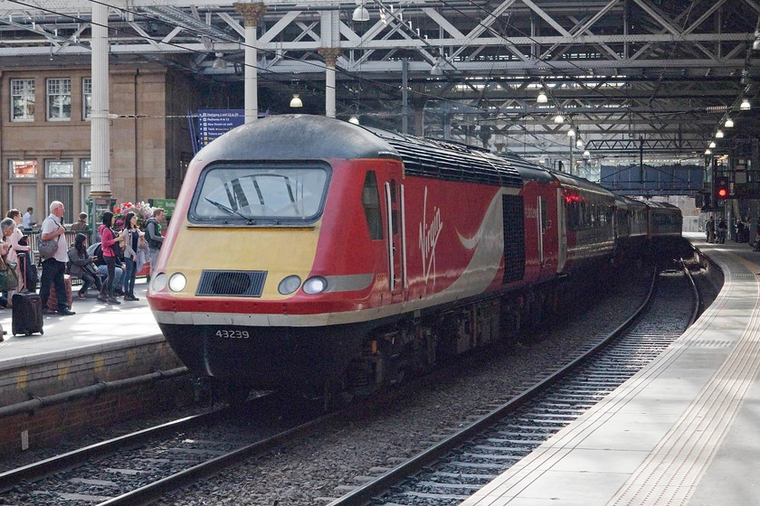 43239, GR 13.47 Aberdeen-London King`s Cross (1E23), Edinburgh Waverley station 
 With the 12.00 King's Cross to Inverness having just vacated platform 2, within a few minutes the 13.47 Aberdeen to King's Cross arrives. 43239 is the leading power car. This was seen earlier in the morning working to Aberdeen almost at the same spot from the footbridge that can be seen up the platforms. At about the time I was taking this image I was asked for my ticket to travel on the steam special and informed that I had to leave this platform as I did not have one. Now, I am an awkward so-and-so and refused that caused quite a stir as I don't think that they were expecting this response. I was informed that the station supervisor would be summoned to deal with me. I moved off before this happened (if it did) because the sun and light would both be completely wrong for photographing the steam special. 
 Keywords: 43239 13.47 Aberdeen-London King`s Cross 1E23 Edinburgh Waverley station