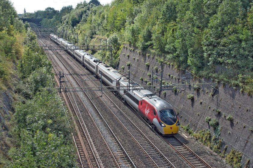 390020, VT 10.36 London Euston-Blackpool North (1P93, 14L), Roade cutting 
 Since the introduction of the direct Blackpool service I have managed to take very few pictures of them. 390020, formally Virgin Cavalier, passes through Roade cutting with the 10.36 Euston to Blackpool North. In my hour of photography in Roade cutting on this morning, this was the only train that was delayed with problems occurring in the Preston area. 
 Keywords: 390020 10.36 London Euston-Blackpool North 1P93 Roade cutting