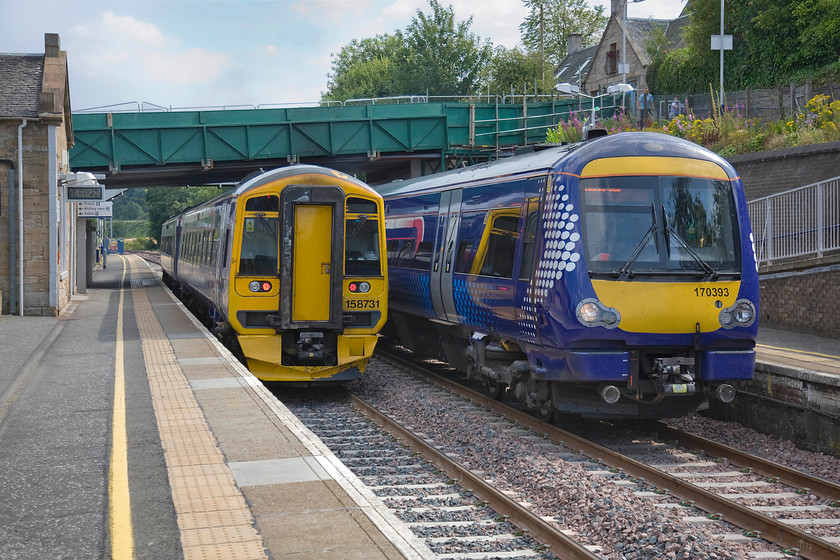 158731, SR 13.28 Dunblane-Edinburgh Waverley (2P40) & 170393, SR 13.33 Edinburgh Waverley-Dunblane (2P65), Polmont station 
 A passing of Edinburgh and Dunblane services takes place at Polmont station. To the left, 158731 leaves with the 13.28 Dunblane to Waverley whilst 170393 arrives with the 13.33 from Edinburgh. Within a few years, these services will be handled by brand new EMUs as electrification transforms this route. 
 Keywords: 158731 13.28 Dunblane-Edinburgh Waverley 2P40 170393 13.33 Edinburgh Waverley-Dunblane 2P65 Polmont station ScotRail