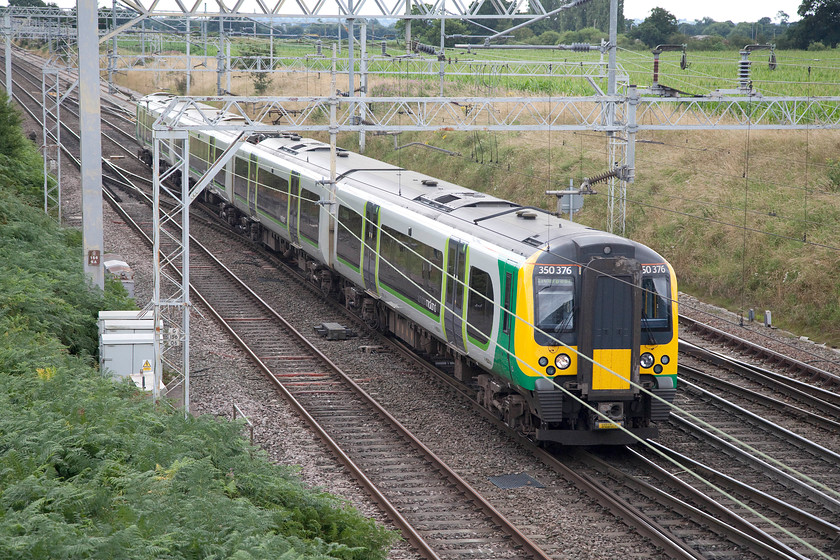 350376, LM 12.36 Birmingham New Street-Liverpool Lime Street (4F43), Casey bridge, Basford Hall Junction 
 350376 is slowing for its stop at Crewe as it passes Casey bridge near to Basford Hall Junction forming the 12.36 Birmingham New Street to Liverpool Lime Street. Another 'through the wires' shot but a better view was not available due to restricted access caused by lineside growth. 
 Keywords: 350376 12.36 Birmingham New Street-Liverpool Lime Street 4F43 Casey bridge, Basford Hall Junction