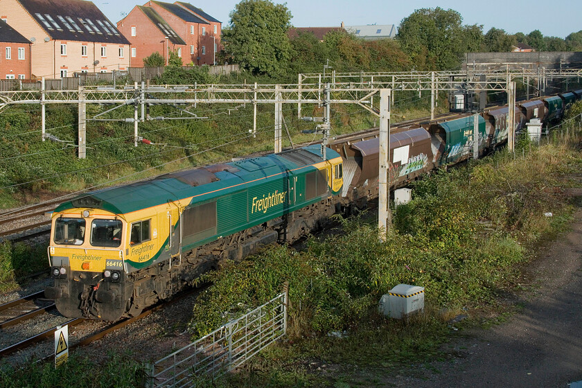 66416, 05.26 Crewe Basford Hall-Wolverton Centre Sidings (4G97, RT), site of Roade station 
 Another movement of redundant HHA coal hoppers passes through Roade led by Freightliner's 66416. Since the decline of coal movements, hundreds of the newer HHA and their older HTA versions are sitting idle in various sidings throughout the country. Like these examples, many are heavily graffitied and crying out for some sort of re-use. The 4G97 has brought a small number down from Crewe Basford Hall to Wolverton Works however I am unsure as to why these ones have moved south. There was a report of a Class 197 heading to Chester a couple of days after this one and that pairs of HHAs were used as barriers. Others are converted for aggregate use which involves them being cut in half and shortened to reduce their capacity as aggregates weigh more than coal meaning that they would not exceed their design axle weight. 
 Keywords: 66416 05.26 Crewe Basford Hall-Wolverton Centre Sidings 4G97 site of Roade station Freightliner