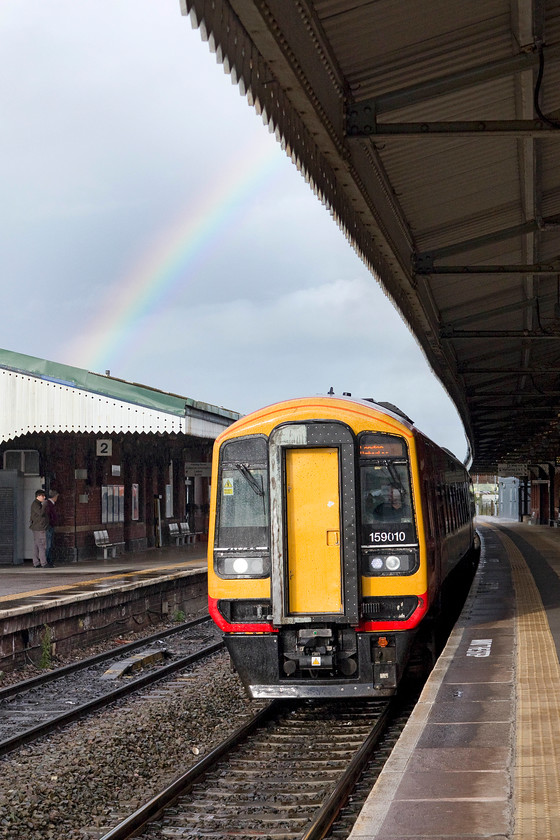 159010, SW 15.51 Bristol Temple Meads-Salisbury & London Waterloo (1O60 & 1L60), Westbury station 
 159010 just catches some late afternoon sunshine that is also creating the rainbow in the sky above it at Westbury station. My wife, son and I had just alighted from the South West Trains service from Bristol to London Waterloo via Salisbury. 
 Keywords: 159010 15.51 Bristol Temple Meads-Salisbury London Waterloo 1O60 1L60 Westbury station