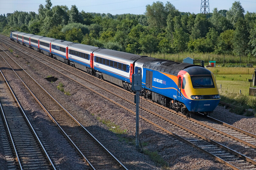 43058, EM 08.15 London St. Pancras-Nottingham (1D12), Lower Farm Road, Bromham TL028518 
 43058 leads the 08.15 St. Pancras to Nottingham HST service. I did not capture the number of the trailing power car as the train passes Bromham between Bedford and Sharbrook Junction on the MML. This is the last few miles of quadruple track on this primary route before the slow lines become just one bidirectional line north from Sharnbrook. 
 Keywords: 43058 EMT East Midlands Trains 08.15 London St. Pancras-Nottingham (1D12), Lower Farm Road, Bromham TL028518