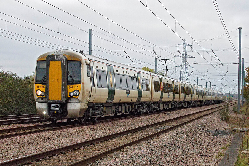 387123, GN 08.13 Peterborough-London King's Cross (1P83, RT), Tempsford level crossing 
 On the up fast line at Tempsford 387123 (along with another unidentified unit at the rear) is probably at its top operating speed of one hundred and ten miles per hour as it heads south working the 08.13 Peterborough to King's Cross Great Northern service. 
 Keywords: 387123 08.13 Peterborough-London King's Cross 1P83 Tempsford level crossing Great Northern Electrostar