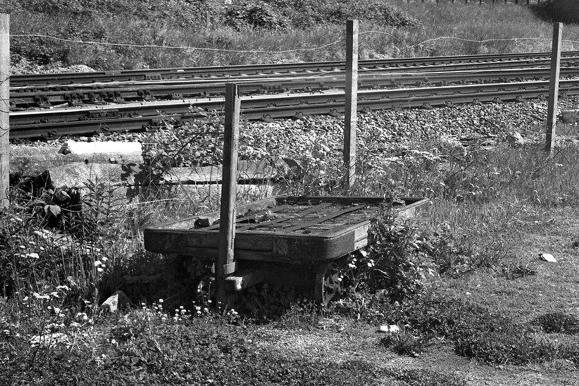 Barrow, Bathampton Junction 
 Bathampton station closed on 03.10.66 and by 1979 there were was little trace of it. However, as can be seen here, there was still a platform barrow sitting almost the weeds with the GWML in the background. The barrow still looks salvageable; I wonder if it was 'acquired' by somebody before the elements consumed it? 
 Keywords: Barrow Bathampton Junction