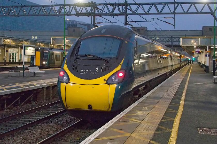 390010, VT 05.42 Wolverhampton-London Euston (1B21, 8L), Milton Keynes Central station 
 The 05.42 Wolverhampton to London Euston pauses at Milton Keynes station worked by 390010. Whilst not a cold start to the day it was very grey and damp with it seemingly taking an age to get light on this particular February morning, that all made a slap-up breakfast with Andy all the more appealing after we had finished our railway business! 
 Keywords: Class 390 05.42 Wolverhampton-London Euston 1B21 Milton Keynes Central station AWC Pendolino Avanti