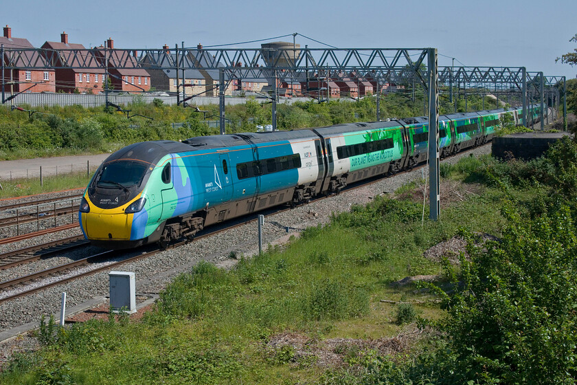 390121, VT 14.29 London Euston-Carlisle (1S72, 16L), site of Roade station 
 Instantly recognisable as 390121 'Opportunity' the uniquely wrapped Avanti Pendolino passes Roade working the 1S72 14.29 Euston to Carlisle service. This train would normally run through to Carlisle but the northern end of the WCML was closed for the completion of extensive engineering and remodelling works at Carstairs. 
 Keywords: 390121 14.29 London Euston-Carlisle 1S72 site of Roade station AWC Avanti West Coast Pendolino