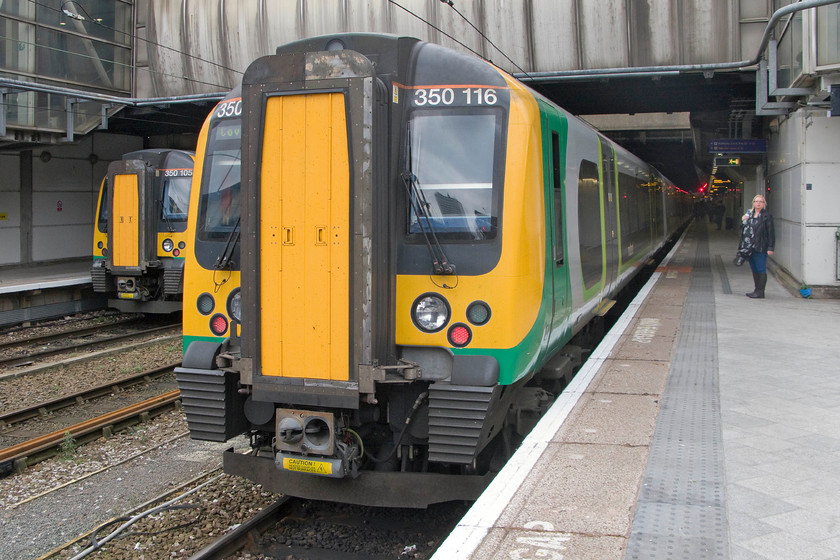 350105, LM 12.35 Birmingham New Street-Liverpool Lime Street (1F41) & 350116, LM 12.36 Birmingham New Street-Coventry (2C15), Birmingham New Street station 
 Two class 350s stand at Birmingham New Stree station. To the far left, 350105 will work the 1F41 12.35 to Liverpool Lime Street whilst 350116 will work the 2C15 12.36 to Coventry. It seems a shame that passengers from the West Midlands going to Liverpool need to change trains at New Street, why can direct service not be operated by London Midland? 
 Keywords: 350105 12.35 Birmingham New Street-Liverpool Lime Street 1F41 350116 12.36 Birmingham New Street-Coventry 2C15 Birmingham New Street station