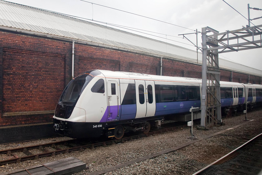 345030, stabled, Crewe LNWR 
 Tucked up against the wall of LNWR's depot is one of Crossrail's new class 345s. This one, 3450030, looks smart in its new livery, I wonder how long it will stay like this crossing underneath London as will do thousands of times when Crossrail eventually opens. 
 Keywords: Crossrail 345030