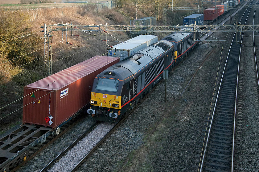 12.32 Crewe BH-Felixstowe N (4L90) & 67005 & 67006, unidentified ex. Wolverton Works working, Victoria Bridge 
 As the 4L90 12.32 Crewe Basford Hall to Felixstowe Freightliner heads south dedicated Royal Train 67005 'Queen's Messenger' and 67006 'Royal Sovereign' head north past Victoria Bridge near Roade in Northamptonshire. The 67s were running light engine from Wolverton Works having deposited the Royal Train stock. As usual, this was an unadvertised working in the working train timetable but inside information goes a long way! 
 Keywords: 12.32 Crewe-Felixstowe 4L90 67005 67006 Royal Train Victoria Bridge