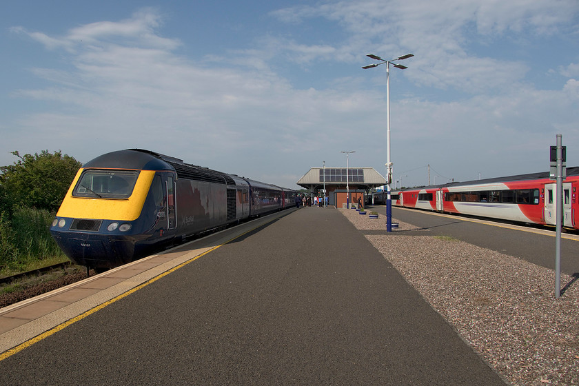 43181, SR 15.28 Edinburgh W-Aberdeen (1A78, 11L), & GR 14.52 Aberdeen-London King s Cross (1E25, 116L), Leuchars station 
 The unusual island platform layout at Leachars enables this picture to be taken of two HST in different eras of their lives. To the right, an LNER set pauses at the station on it way south forming the 1A78 14.52 Aberdeen to King's Cross. Meanwhile, to the left, ex-Great Western set, now one of ScotRail's short sets with 43181 at the rear is seen forming the 15.28 Edinburgh to Aberdeen. Leachars station was a really nice place that was pleasingly busy. Notice the newly constructed red brick-built structure on the station platform. This is Caledonian Sleeper's lounge for their customers whilst waiting for the arrival of their southbound service. 
 Keywords: 43181 15.28 Edinburgh Waverley-Aberdeen 1A78 14.52 Aberdeen-London King's Cross 1E25 Leuchars station